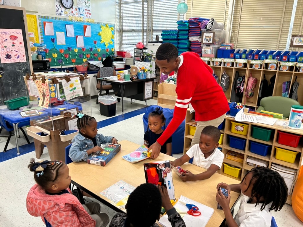 Brother reading with elementary school students